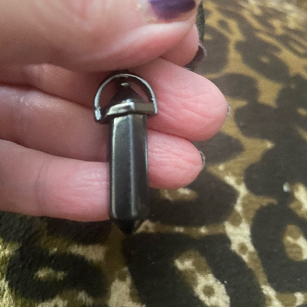 Black Crystal Pendant on a black cord also attached is a evil eye necklace